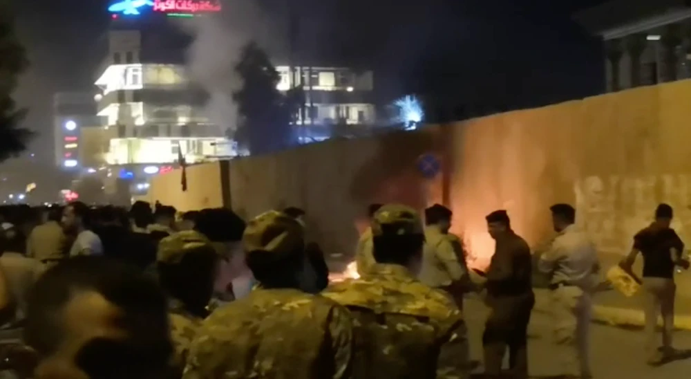 Protesters lowered the flag and set fire to the outer wall of the consulate as staff fled through the back door(Screengrab from video supplied to AN)