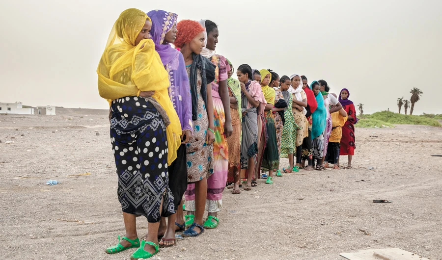 Ethiopian migrants stand in line to be counted by smugglers in Lahj, Yemen after arriving to the coastal village of Ras Al-Ara from Djibouti. (AP)