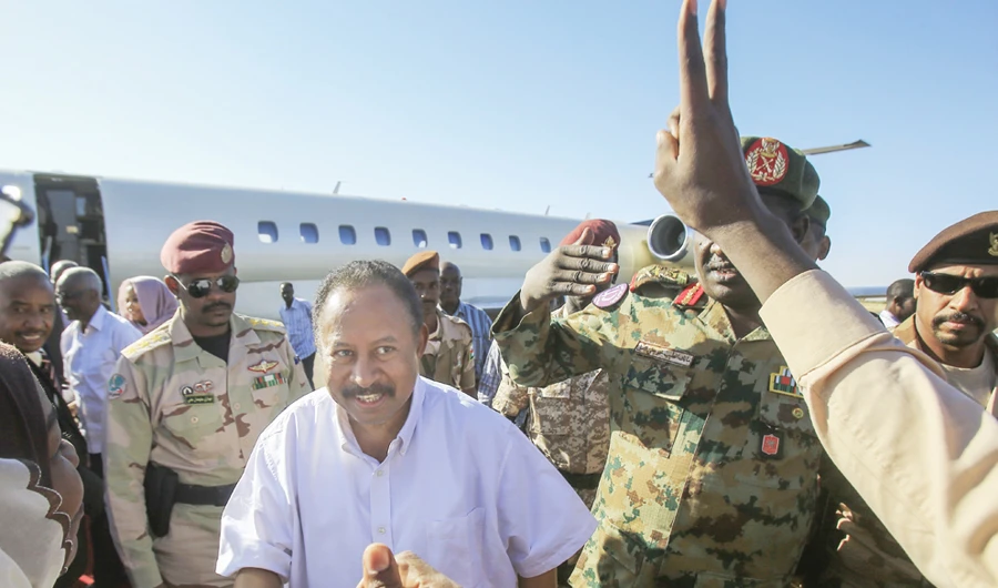 Sudan's Premier Abdalla Hamdok is greeted on Monday by supporters upon arriving in El-Fasher, capital of the North Darfur state, on a one-day visit. (AFP)