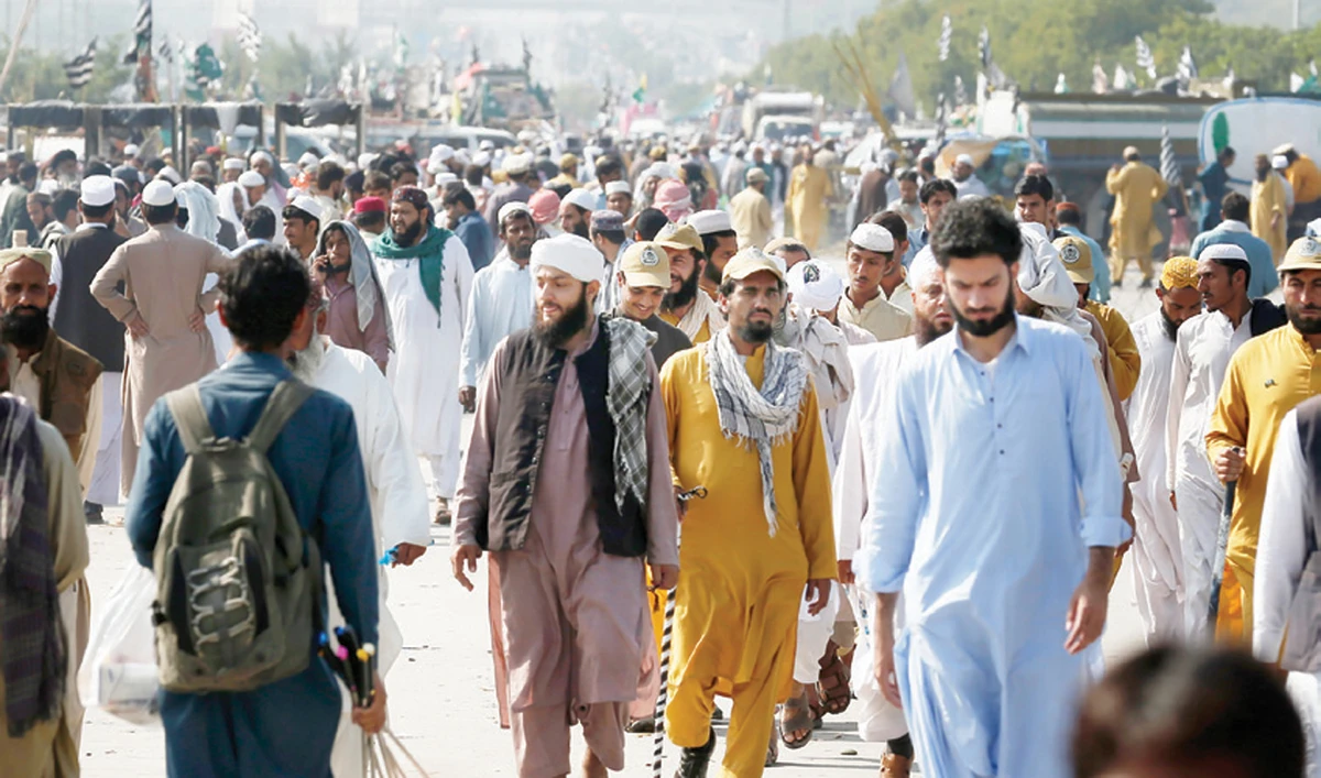 Supporters of Jamiat Ulema-e-Islam walk on a section of road closed for an anti-government march, in Islamabad on Sunday. (AP)
