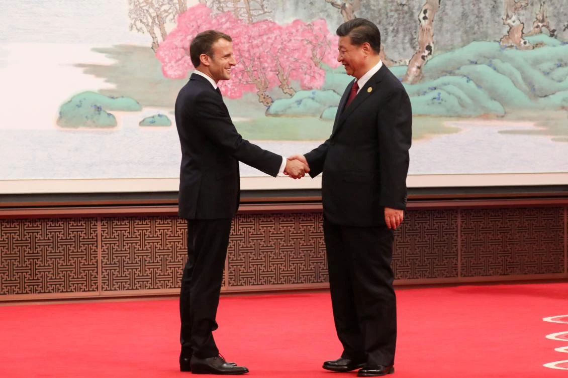 China’s President Xi Jinping (R) shakes hands with French President Emmanuel Macron during the China International Import Expo in Shanghai on november 5, 2019. (File/AFP)