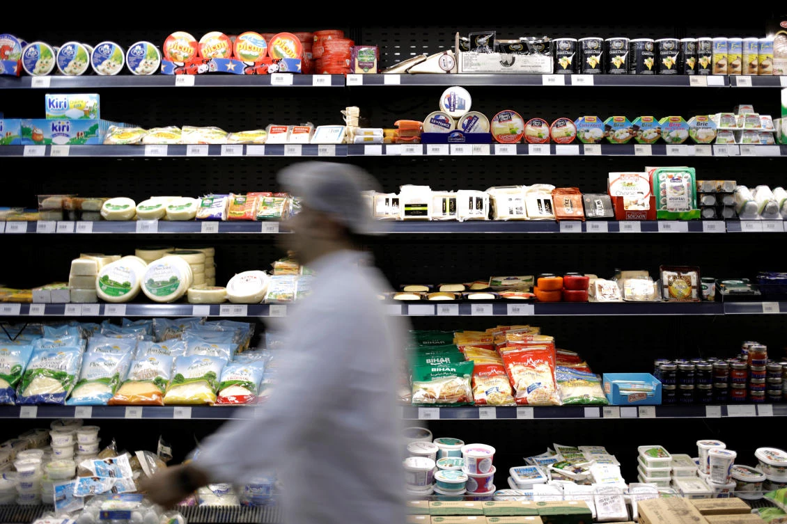 A worker walks past food items displayed for sale inside a supermarket in Beirut, Lebanon November 5, 2019. (Reuters)