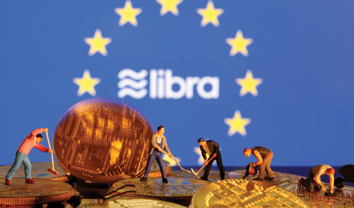 The illustration shows toy figures on representations of the virtual currency before the EU flag and the Facebook Libra logo. Reuters text, Caption text, Caption text. Reuters