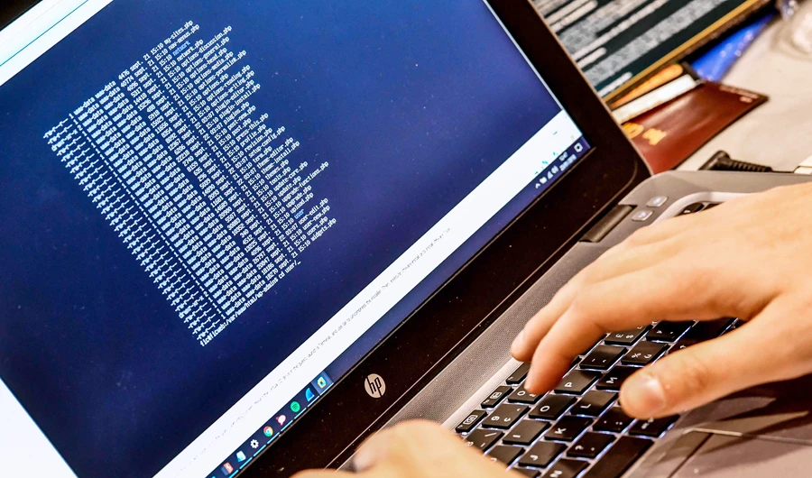 In this file photo taken on January 23, 2018 a person works at a computer during the 10th International Cybersecurity Forum in Lille, France. (AFP)