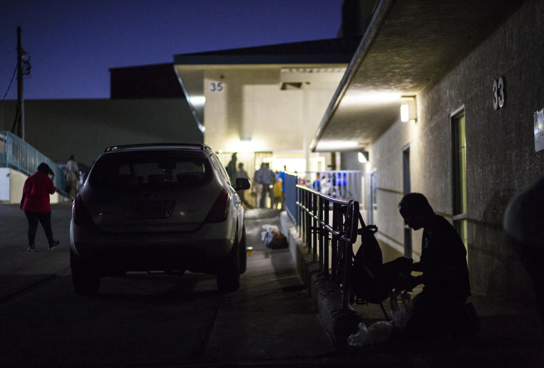 This Oct. 15, 2019, file photo shows a patron of The Salvation Army homeless shelter, right, checking his belongings at a shelter near downtown Las Vegas. (AP)