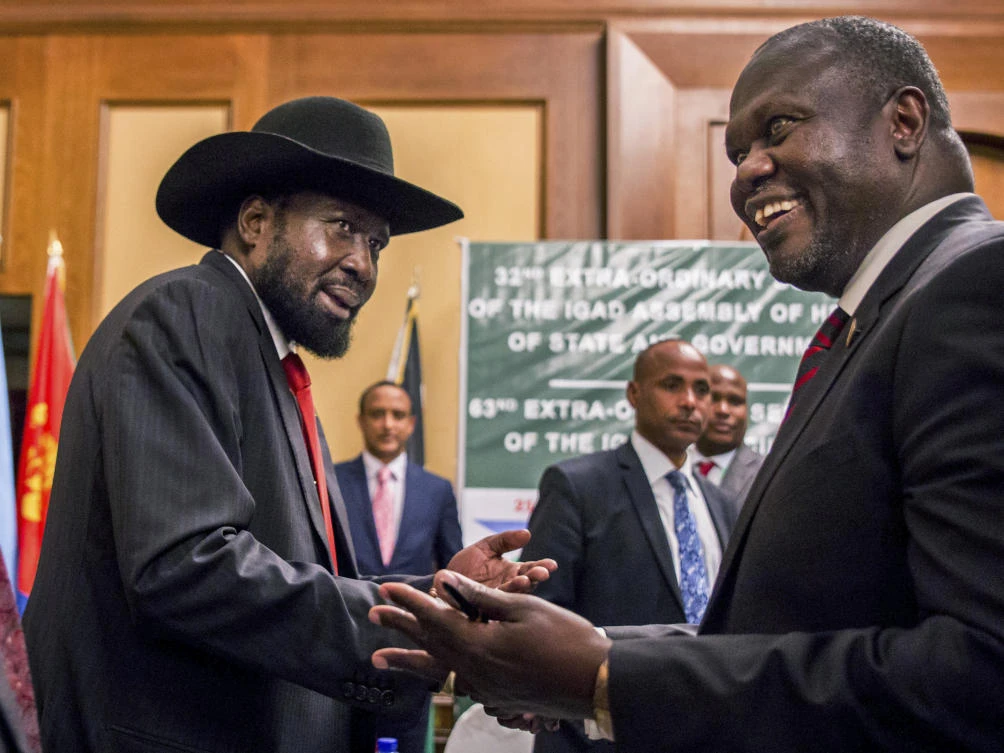 In this Thursday, June 21, 2018 file photo, South Sudan's President Salva Kiir, left, and opposition leader Riek Machar shake hands during peace talks in Addis Ababa, Ethiopia. (AP)