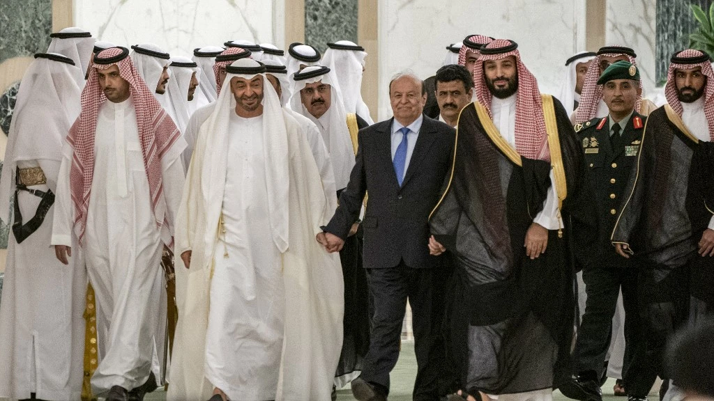 Crown Prince of Abu Dhabi Sheikh Mohamed bin Zayed al-Nahyan (C-L) walking alongside Yemen's President Abedrabbo Mansour Hadi (C) and Saudi Crown Prince Mohammed bin Salman (C-R) as they attend a peace-signing ceremony between the Saudi-backed Yemeni government and the southern separatists in the capital Riyadh. (AFP)
