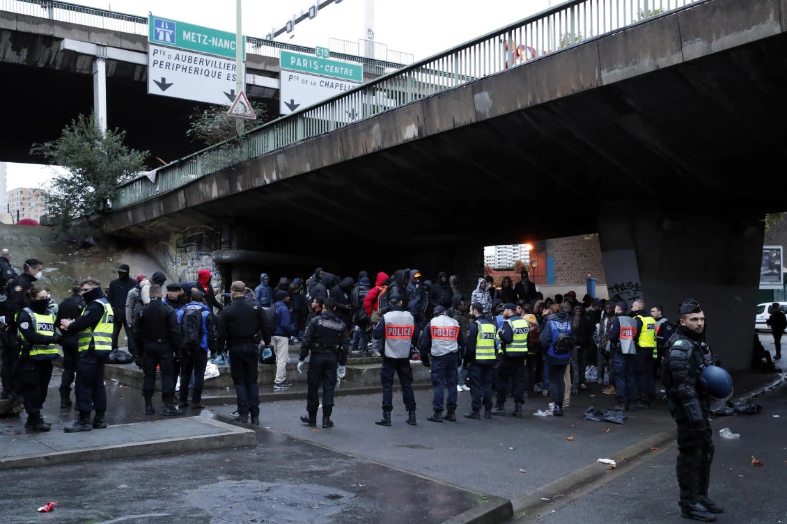 French Police officers conduct an operation to dismantle makeshift migrant camps in the north of Paris. (AP Photo)