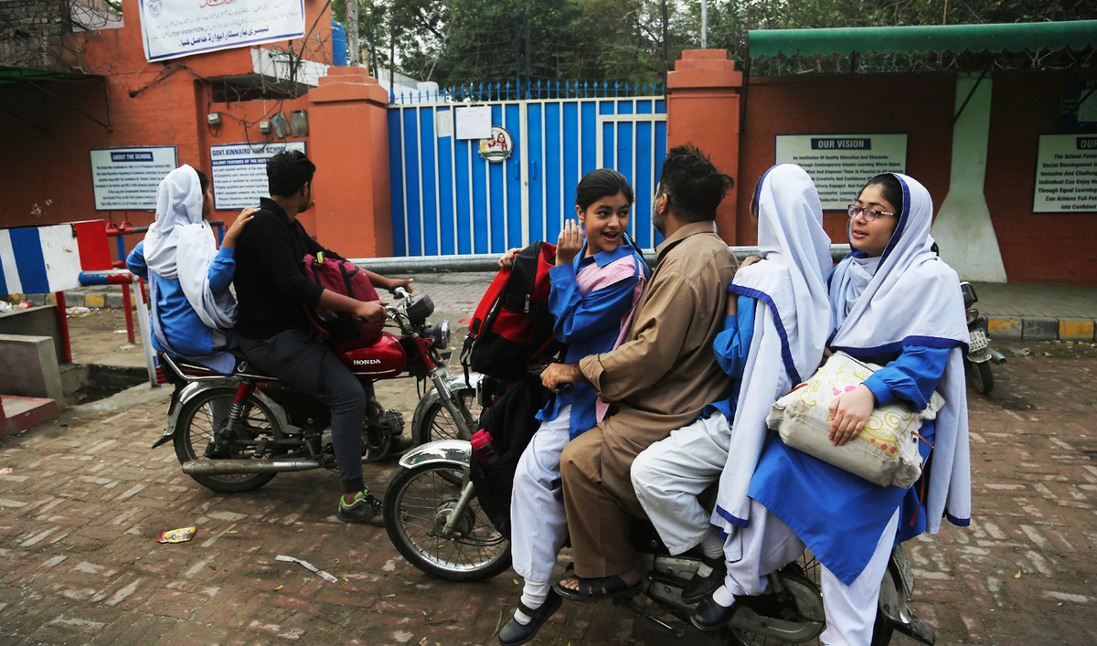 Pakistani students stand outside their school which is closed due to poor air quality in Lahore, Pakistan. (AP)