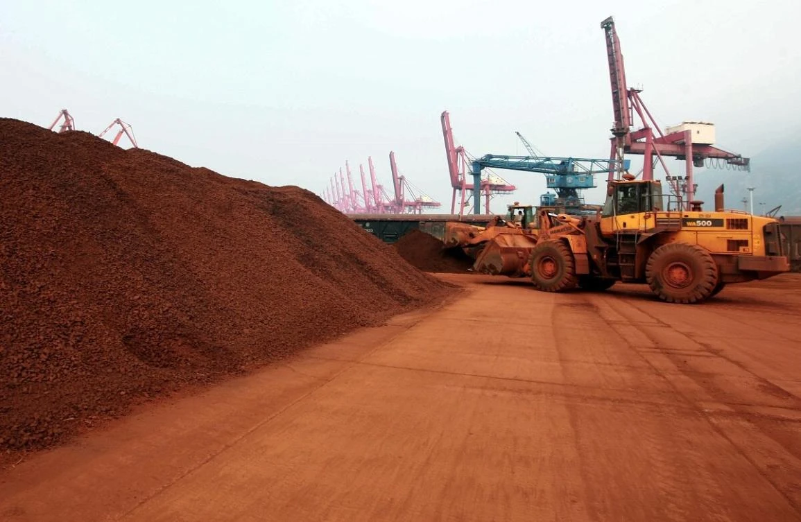 A front loader shifts soil containing rare earth minerals to be loaded at a port in Lianyungang, in east China's Jiangsu province, for export. (AFP)