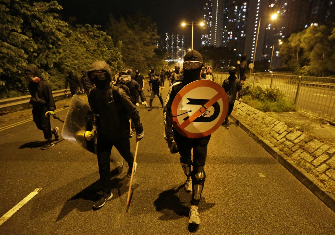 Protesters use road signs as shields during an anti-government rally in Hong Kong early Saturday, Nov. 9, 2019. (AP)