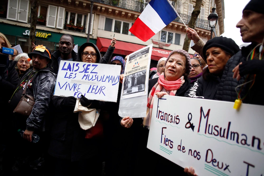 Protesters hold placards during a demonstration against Islamophobia, in Paris, Sunday, Nov. 10, 2019. Placard on the left reads: ” Let muslims live their faith.” (AP)