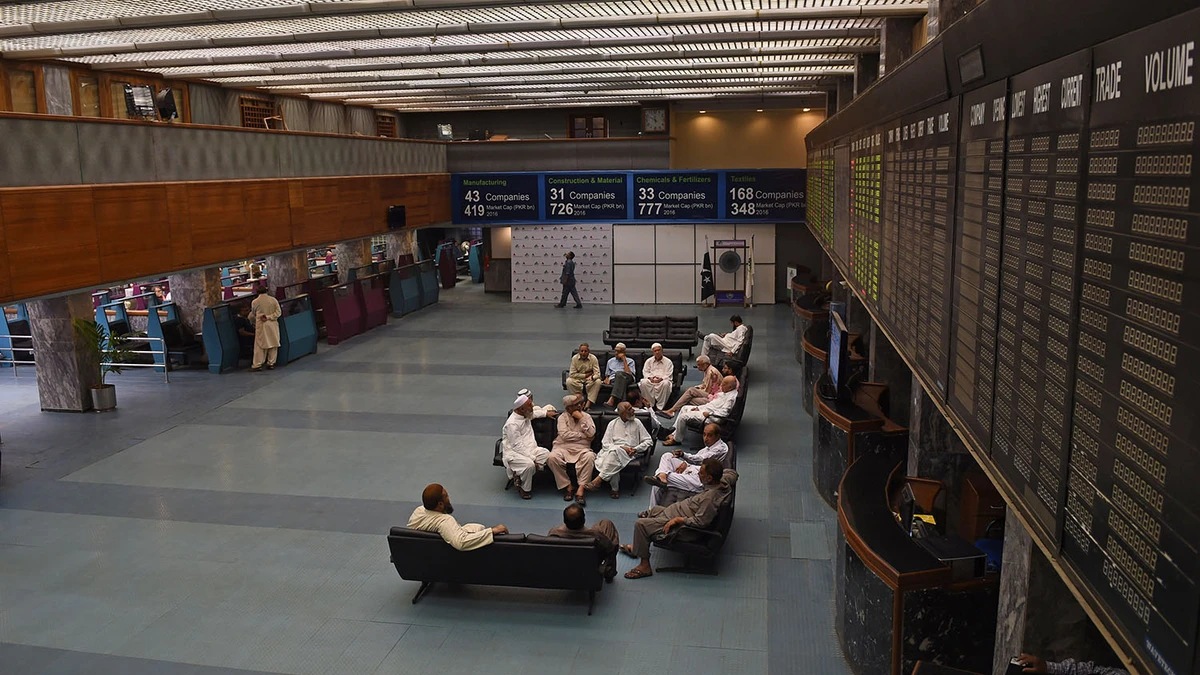 In this file photo, Pakistani stockbrokers sit near a share prices board during a trading session at the Pakistan Stock Exchange (PSX) in Karachi on Oct. 18, 2016. (AFP)