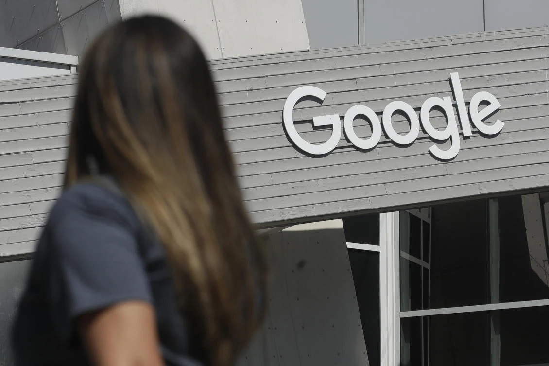 In this Sept. 24, 2019, file photo a woman walks below a Google sign on the campus in Mountain View, Calif. (AP)