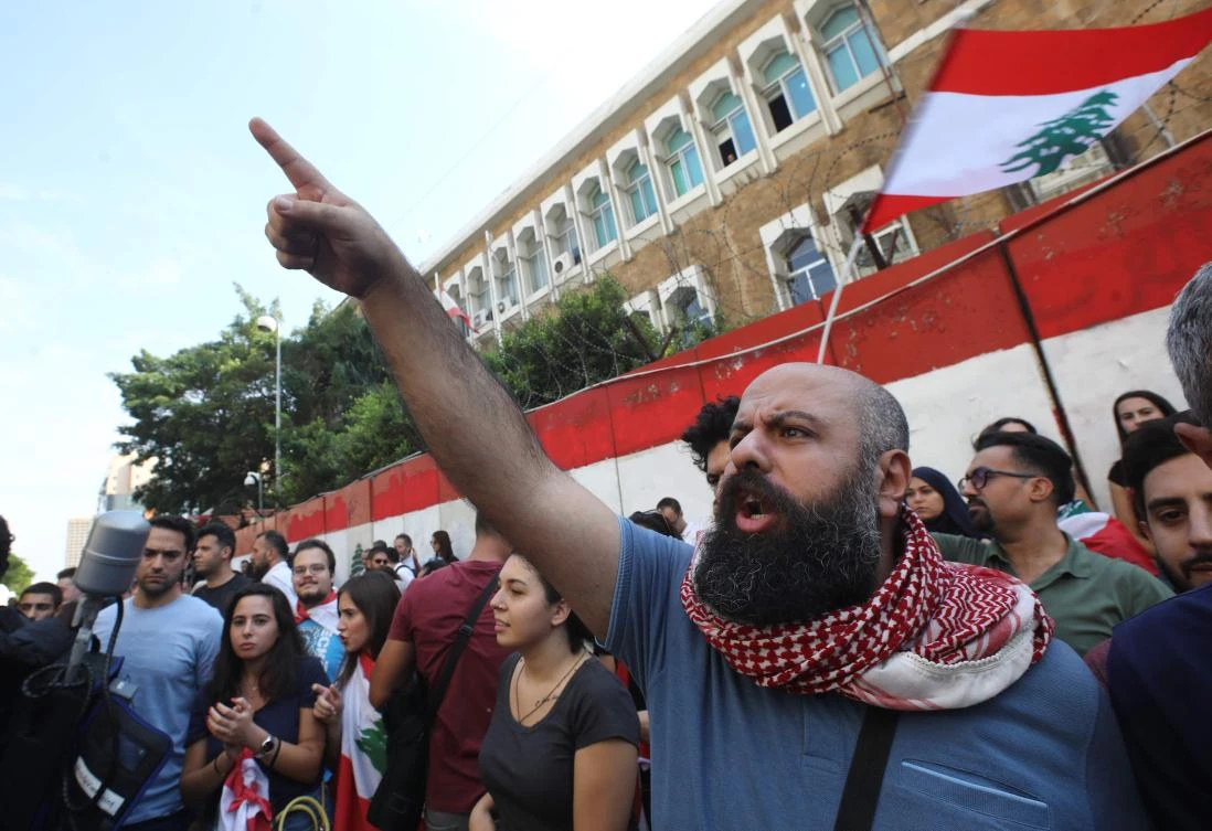 Protesters gather outside the central bank of Lebanon to rally against the financial measures adopted by the Banque du Liban. (AFP)