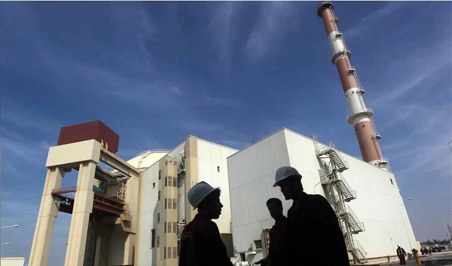 Iranian workers stand in front of the Bushehr nuclear power plant, about 1,200 km (746 miles) south of Tehran, Iran, October 26, 2010. (REUTERS/File Photo)