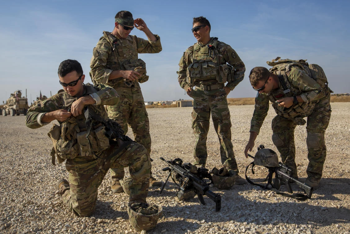 Crewmen rest their weapons after training with Bradley fighting vehicles at a US military base at undisclosed location in Northeastern Syria, Monday, Nov. 11, 2019. (AP)