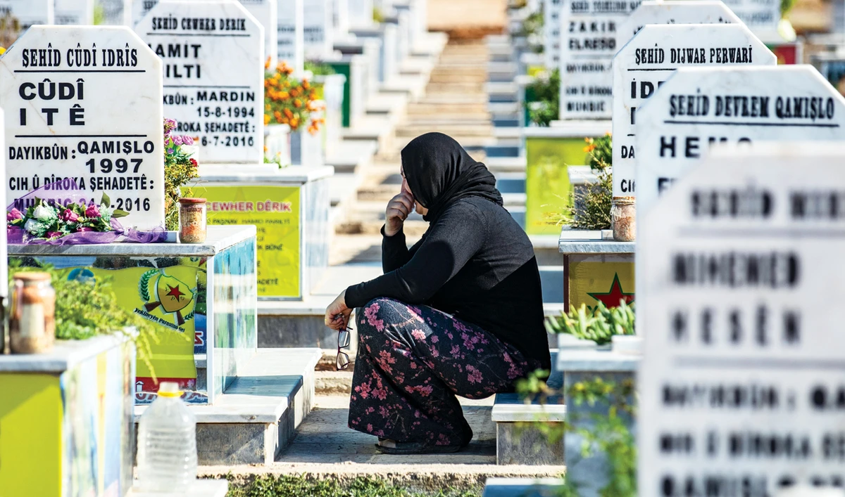 A Syrian Kurdish woman mourns in Qamishli in the northeastern Hassakeh province for fighters from the Kurdish Syrian Democratic Forces killed during clashes with Turkish and Ankara-backed forces. (AFP)