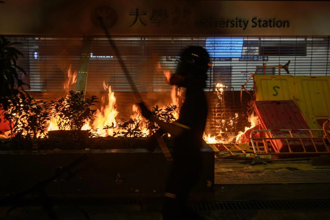 Protesters burn the entrance gate of a metro station after the clashes with protesters at the Chinese University of Hong Kong (CUHK), in Hong Kong on November 13, 2019. (File/AFP)