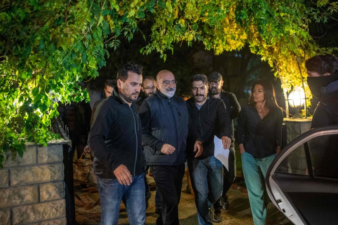 Journalist and writer Ahmet Altan walks with Turkish police as his daughter Senem Altan tries to say him goodbye as he is detained on November 12, 2019, at Kadikoy neighbourhood in Istanbul. (File/AFP)