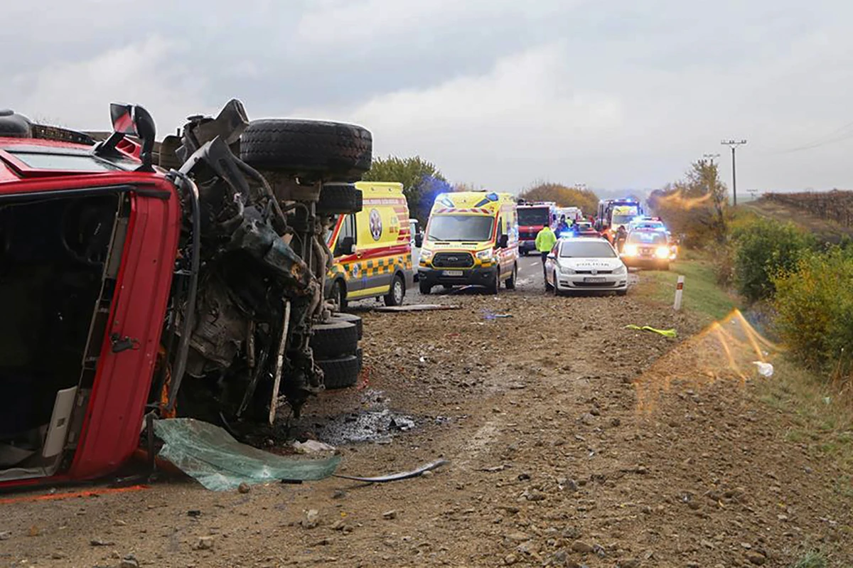 This Handout picture made available by the Slovak Police on November 13, 2019, shows the emergency services working at the scene of collision between a public bus and a truck near the village of Malanta on the outskirts of the city of Nitra, Slovakia. (AFP)