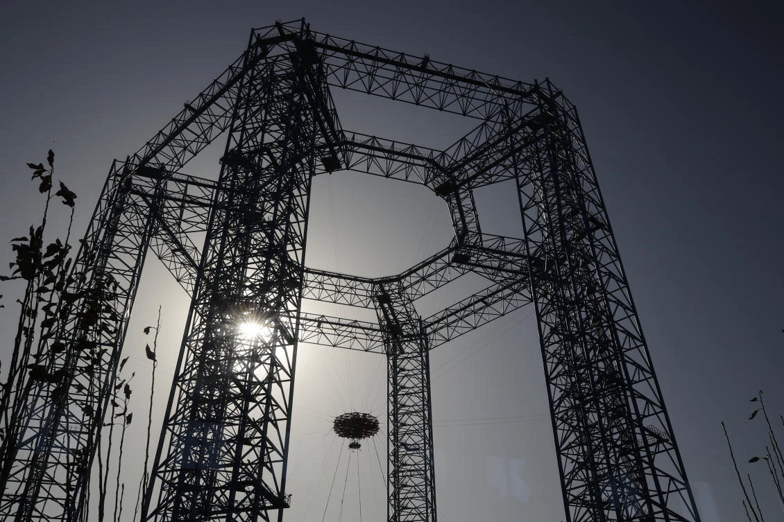 A lander is lifted during a test of hovering, obstacle avoidance and deceleration capabilities at a facility in Huailai in China's Hebei province, Thursday, Nov. 14, 2019. (File/AFP)