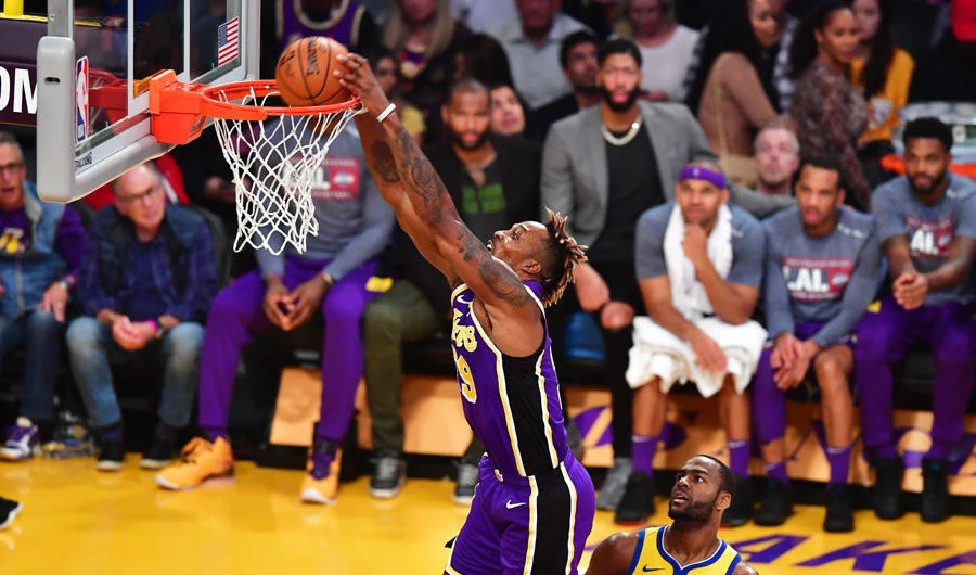 Dwight Howard of the Los Angeles Lakers scores as Alec Burks of the Golden State Warriors watches during their the regular season game at the Staples Center in Los Angeles on Nov. 13, 2019. (AFP / Frederic J. Brown)