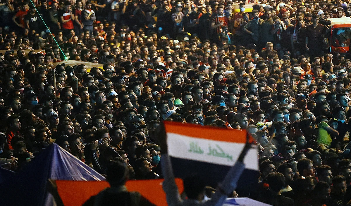 Iraqi demonstrators gathered at a Al- Tahrir square watch the World Cup 2022 Qualifier match Iraq v Iran, in Baghdad, Iraq. (Reuters)