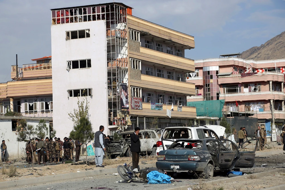 Afghan security personnel gather at the site of a recent car bomb attack in Kabul. (AP)