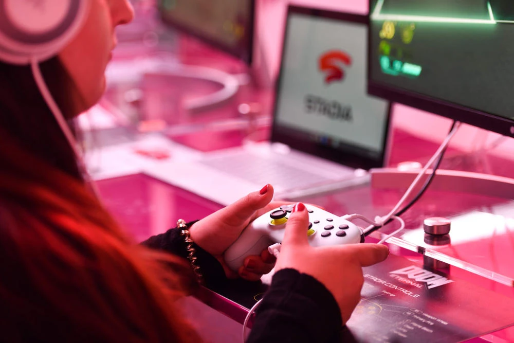 In this file photo taken on August 21, 2019 a visitor plays a cloud-game at the stand of Google Stadia during the Video games trade fair Gamescom in Cologne, Germany. (AFP / Ina Fassbender)