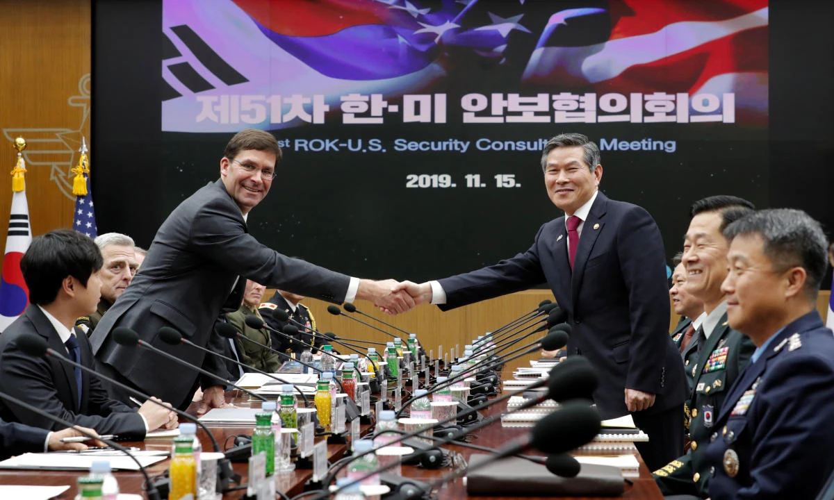 US Defense Secretary Mark Esper, left, and South Korean Defense Minister Jeong Kyeong-doo shake hands prior to their meeting in Seoul on Friday, Nov. 15, 2019. (Reuters)