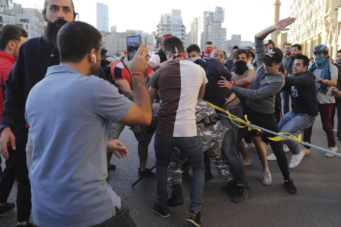 Protests force Lebanese parliament to postpone session, banks reopen