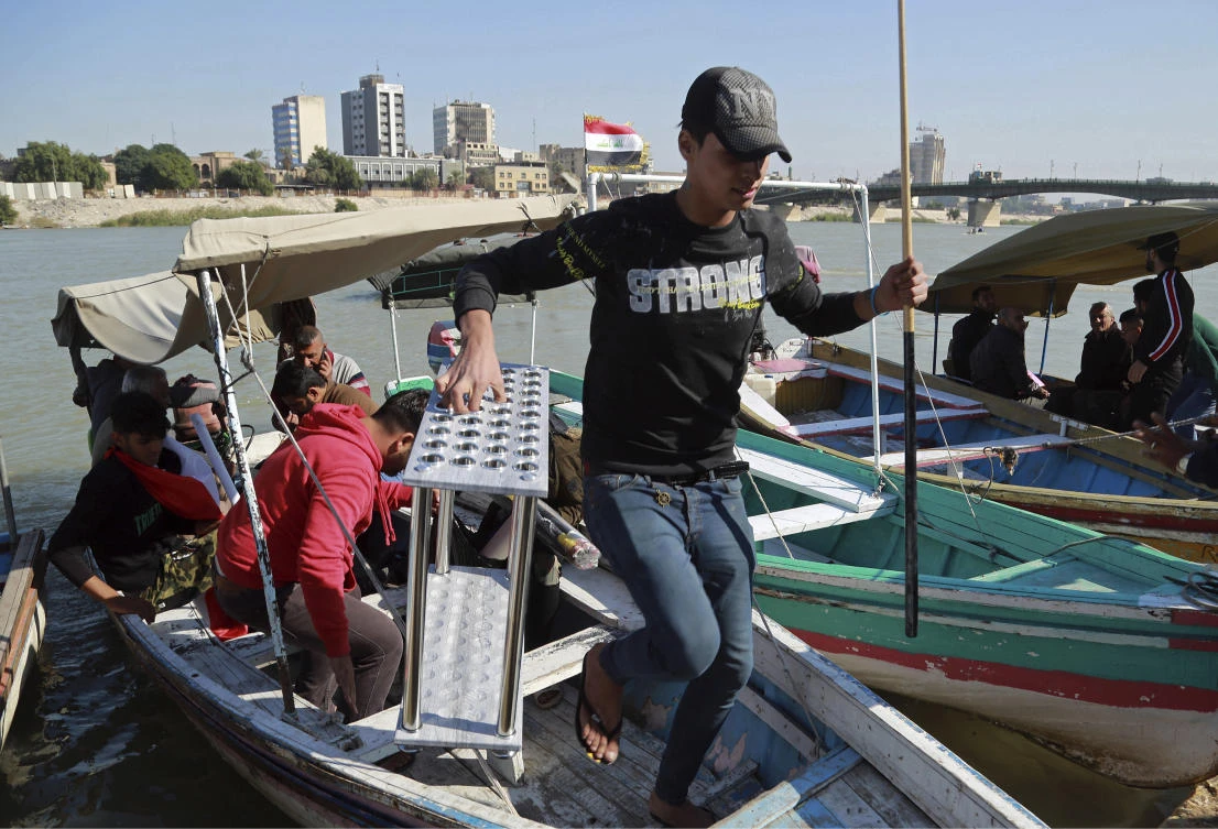 People cross the Tigris River in central Baghdad, Iraq, Tuesday, Nov. 19, 2019. (AP)