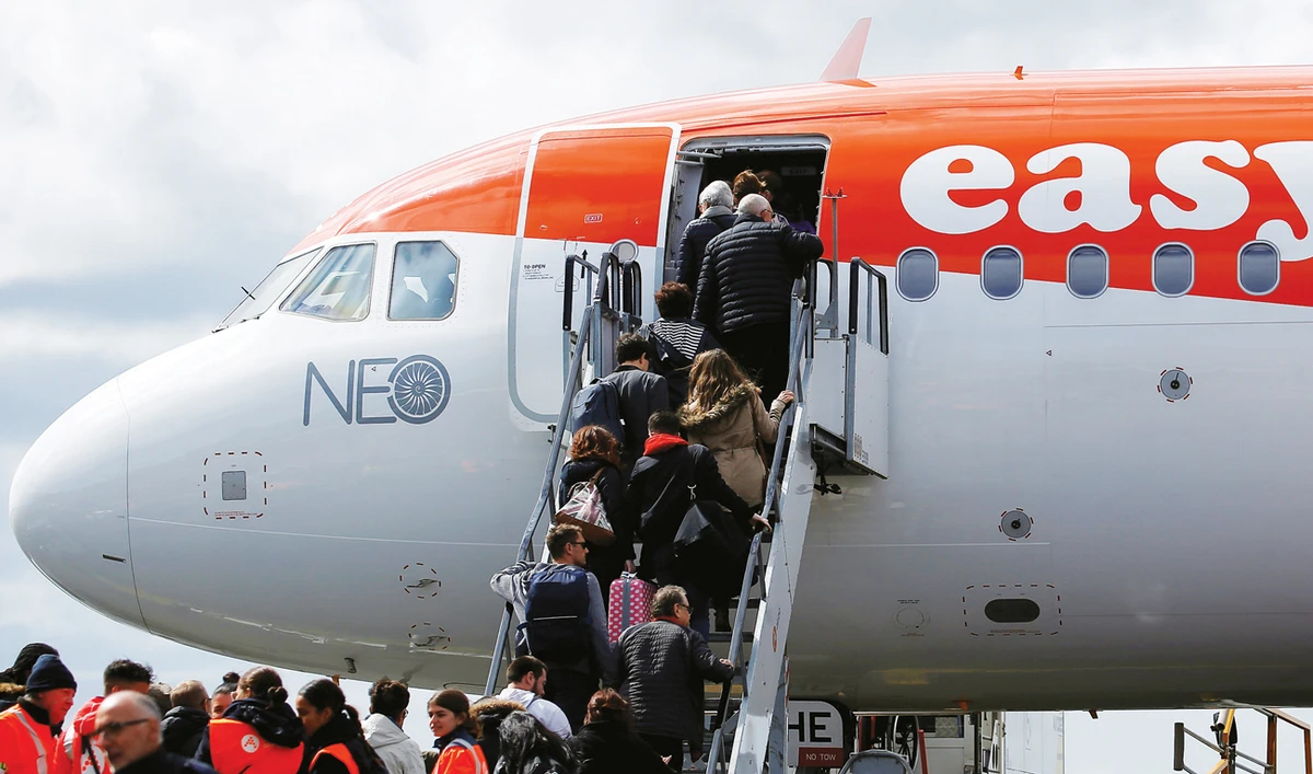 Passengers board an easyJet plane at the Nantes Atlantique airport in France. Airlines are under increasing pressure to reduce emissions. (Reuters)