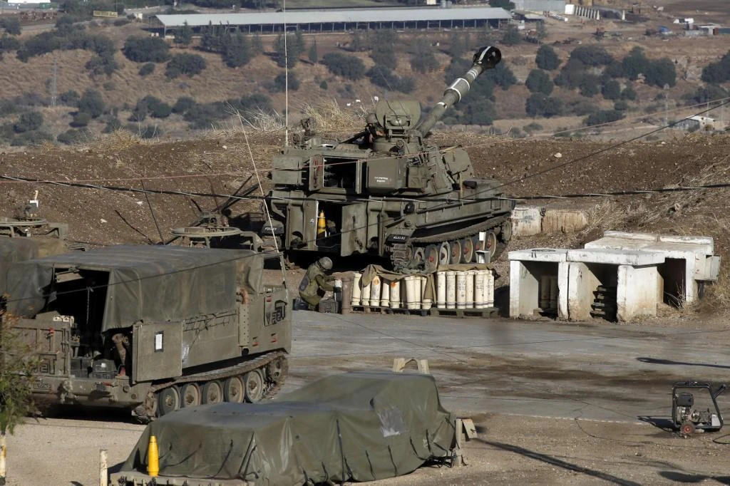 Above, Israeli soldiers and armored vehicles near the border with Syria in the annexed Golan Heights. Israel confirmed it launched air raids against military site in the Syrian capital of Damascus. (AFP)
