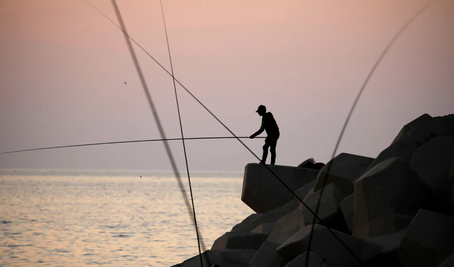 A boy fishes from a breakwater in Antelias, Lebanon November 20, 2019. (Reuters)