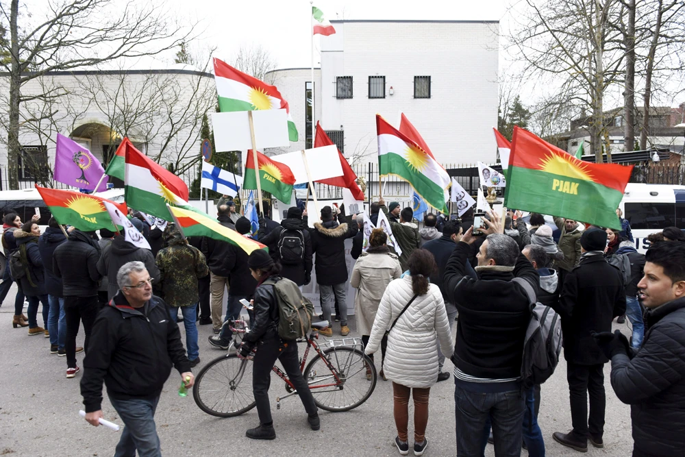 People attend a protest to support the demonstrations in Iran against the rise in gasoline prices outside the Embassy of Iran in Helsinki, Finland, on Nov. 21, 2019,(Lehtikuva/Heikki Saukkomaa via REUTERS)