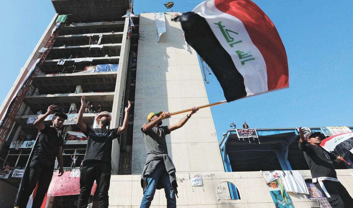 Demonstrators gesture as they take part in ongoing anti-government protests in Baghdad on Thursday. (Reuters)
