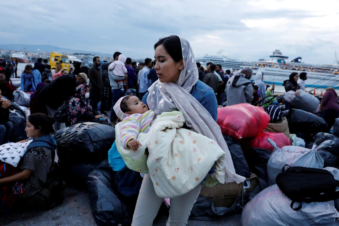 A woman holds her baby as refugees and migrants arrive on a passenger ferry from the island of Lesbos at the port of Piraeus, Greece, October 7, 2019. (Reuters/ File Photo)
