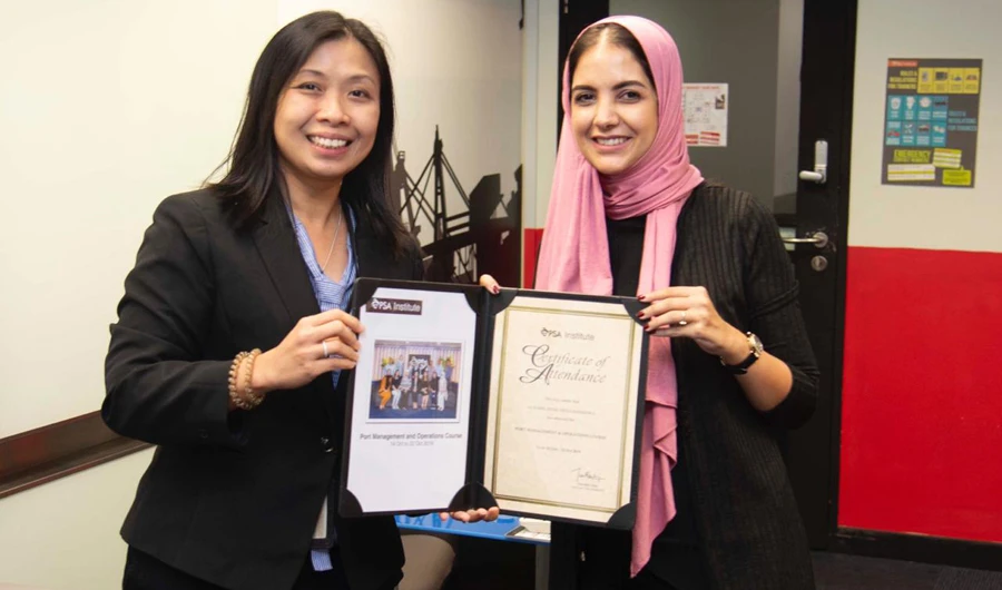 A workshop participant, right, poses with her certificate. For this year’s workshop, SGP sent four female operations officers, while MAWANI’s delegation consisted of five female Saudi nationals.
