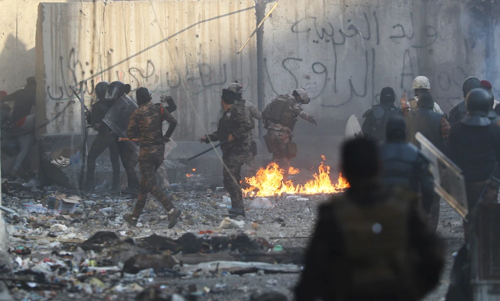 Iraqi security forces clash with demonstrators in Baghdad on Saturday. (Reuters)