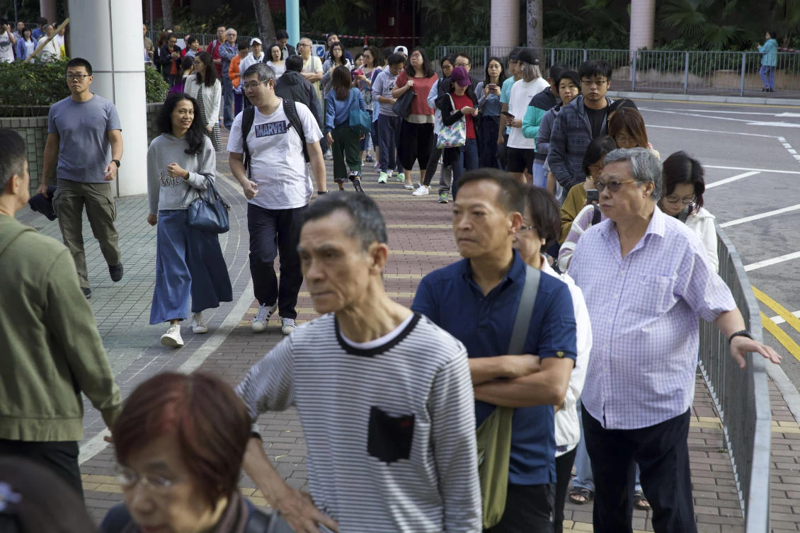 A record 1,104 candidates are vying for 452 seats and a record 4.1 million Hong Kong people have enrolled to vote. (AP)