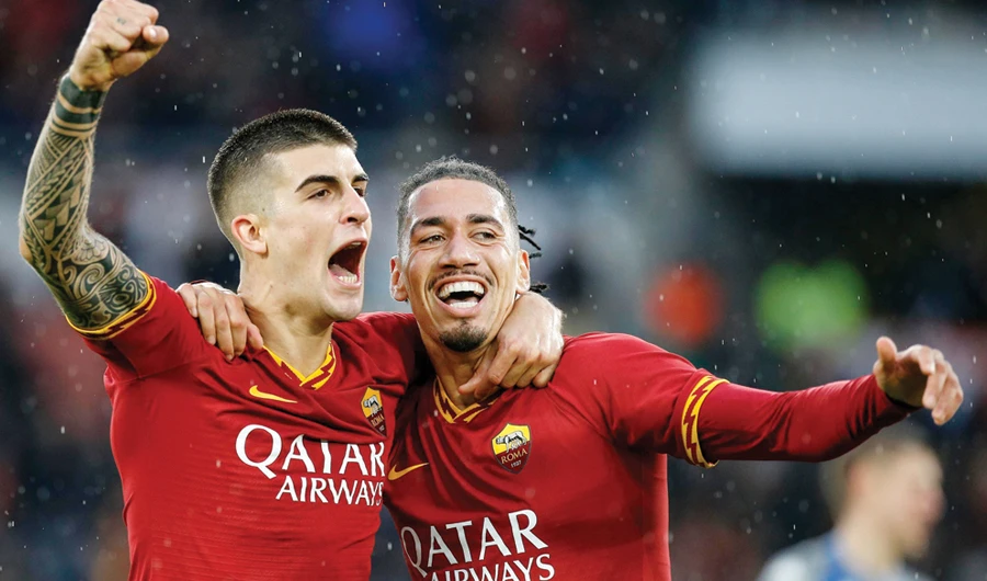 Roma’s Gianluca Mancini, left, celebrates with his teammate Chris Smalling after scoring his side’s second goal. (AP)