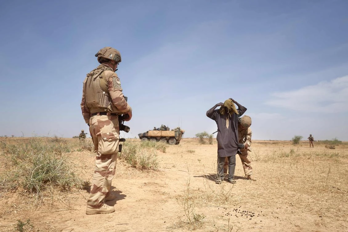 A herder suspected to be affiliated with militants in northern Burkina Faso is searched by a French soldier during the Bourgou IV operation on November 11, 2019. (AFP)