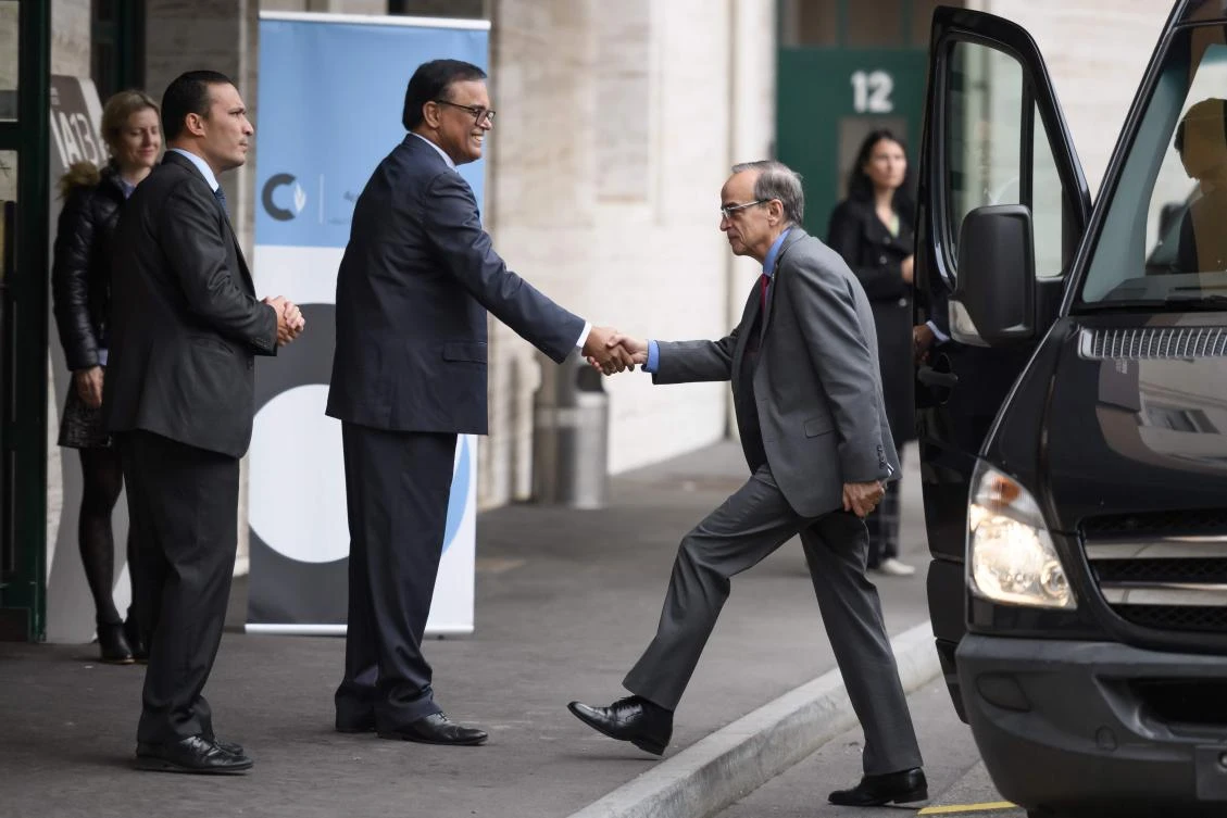 Co-chair and opposition Syrian Negotiations Commission head Hadi Al-Bahra (C) is greeted upon his arrival for a new round of discussions of the Syria constitution-writing committee on November 25, 2019 at the United Nations Offices in Geneva. (AFP)