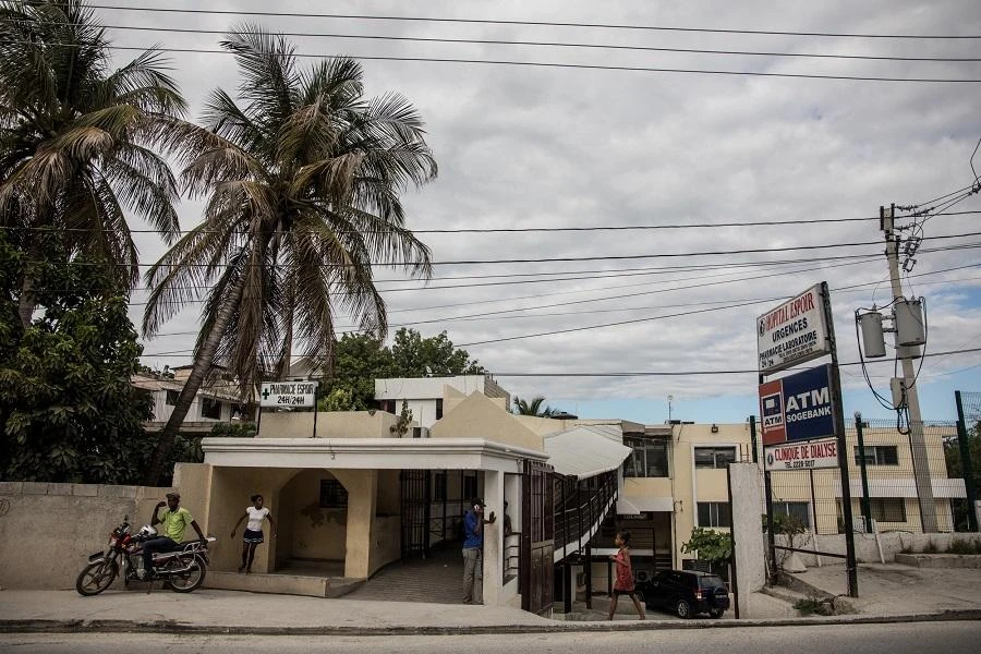 People stand outside a hospital in Delmas 75 in Por-au-Prince on November 25, 2019, where two French citizens were transported after they were shot dead in Port-au-Prince over the weekend. (File/AFP)
