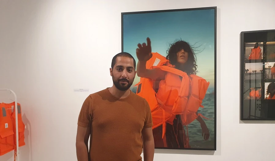 Moez Achour stands in front of his work. Supplied