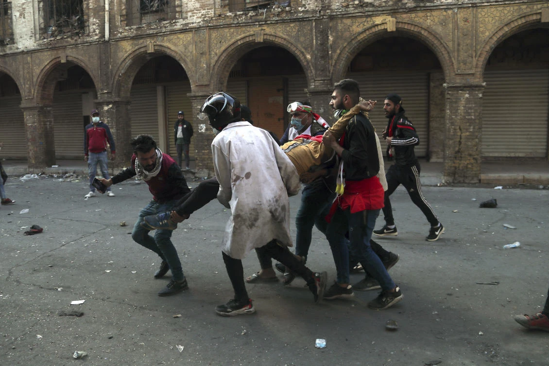 An injured protester is carried away during clashes between security forces and anti-government demonstrators in Baghdad, Iraq, Friday, Nov. 22, 2019. (AP)