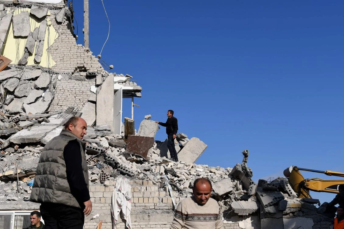 Emergency workers clear debris at a damaged building in Thumane, 34 kilometers northwest of capital Tirana, after an earthquake hit Albania. (AFP)