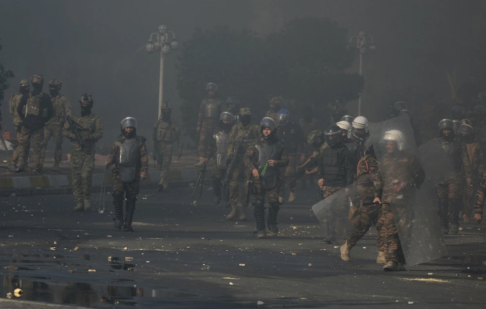 Iraqi security forces clash with demonstrators during ongoing anti-government protests in Nassiriya, Iraq on Thursday. (Reuters)